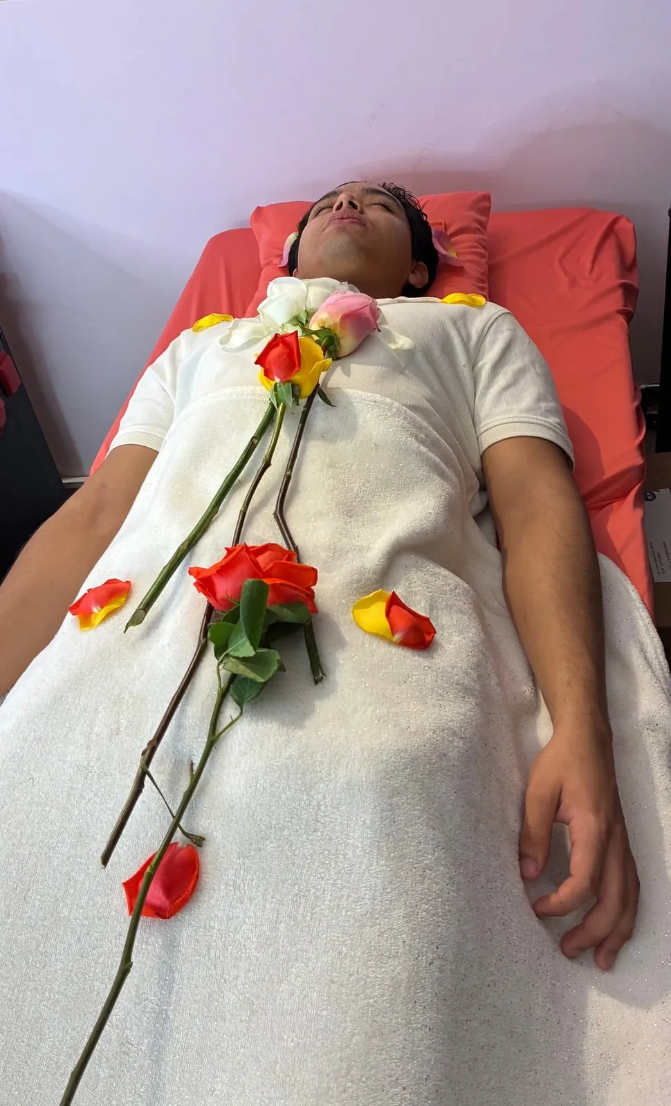 Sesión de Sanación con Rosas: rosas rojas y amarillas sobre una persona recostada